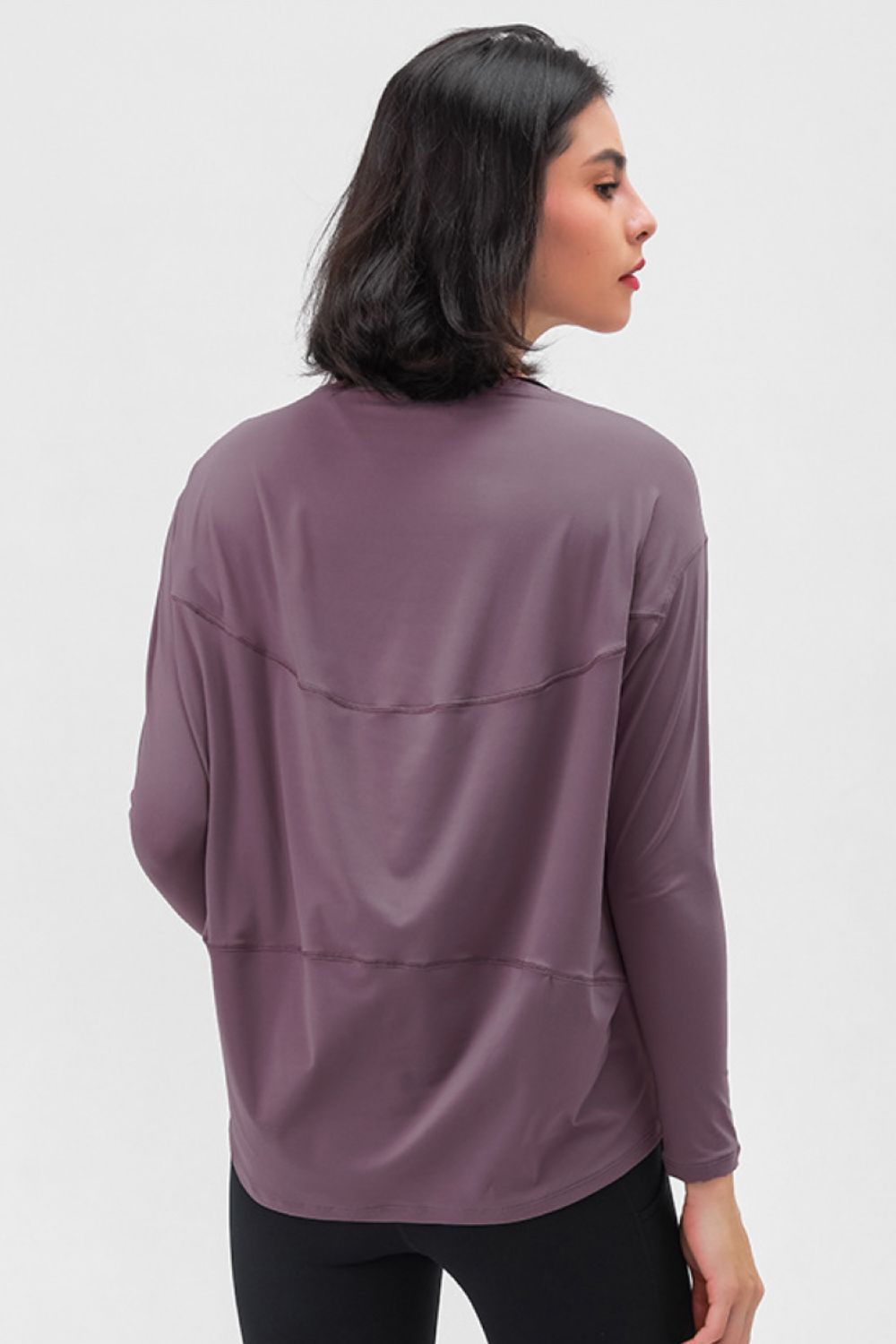 Loose-fit active top in mauve, back view with seam and curved yoke detail.
