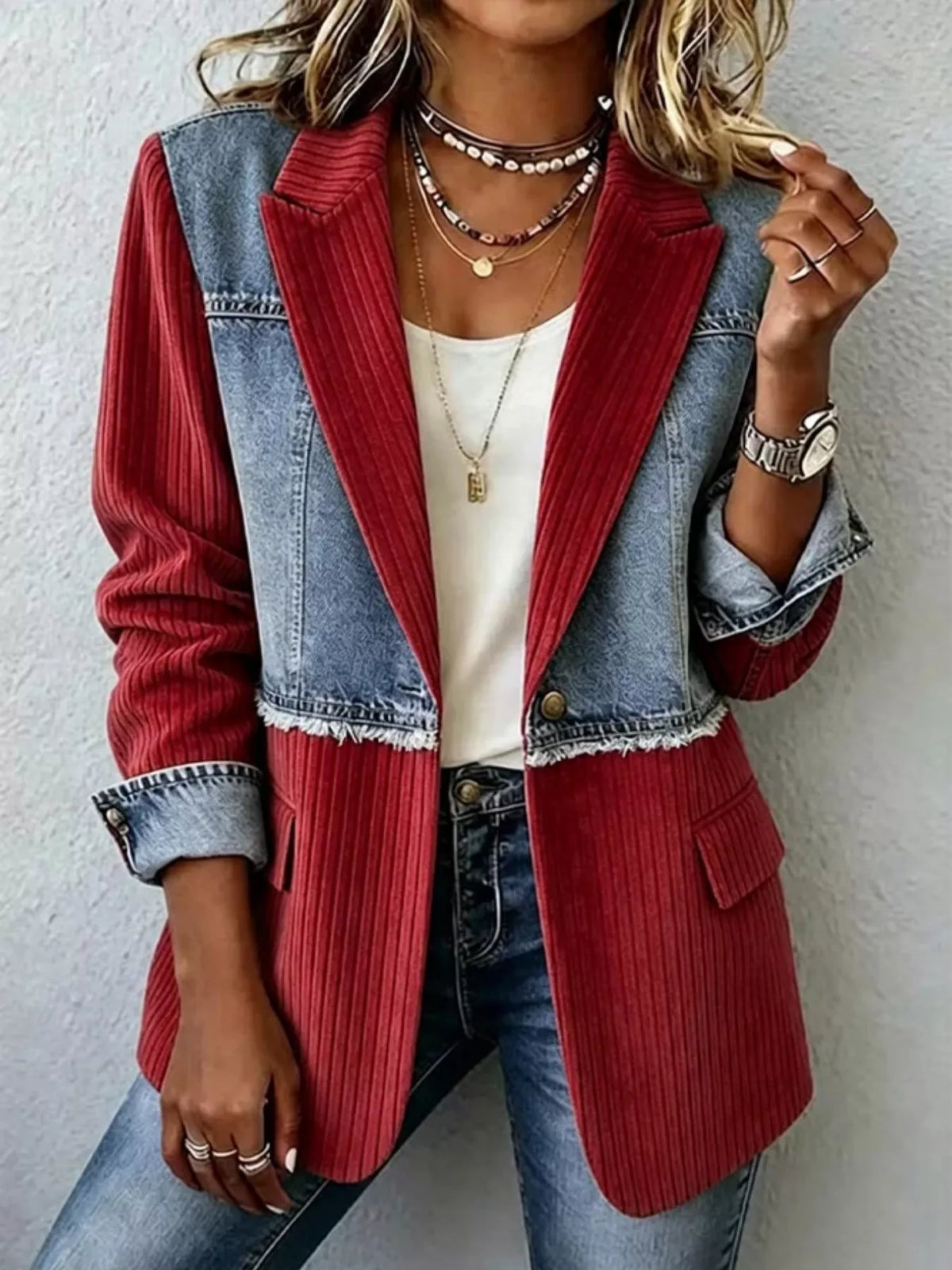 Patchwork denim blazer with ribbed red panels, notch lapel, flap pockets, fringe hem