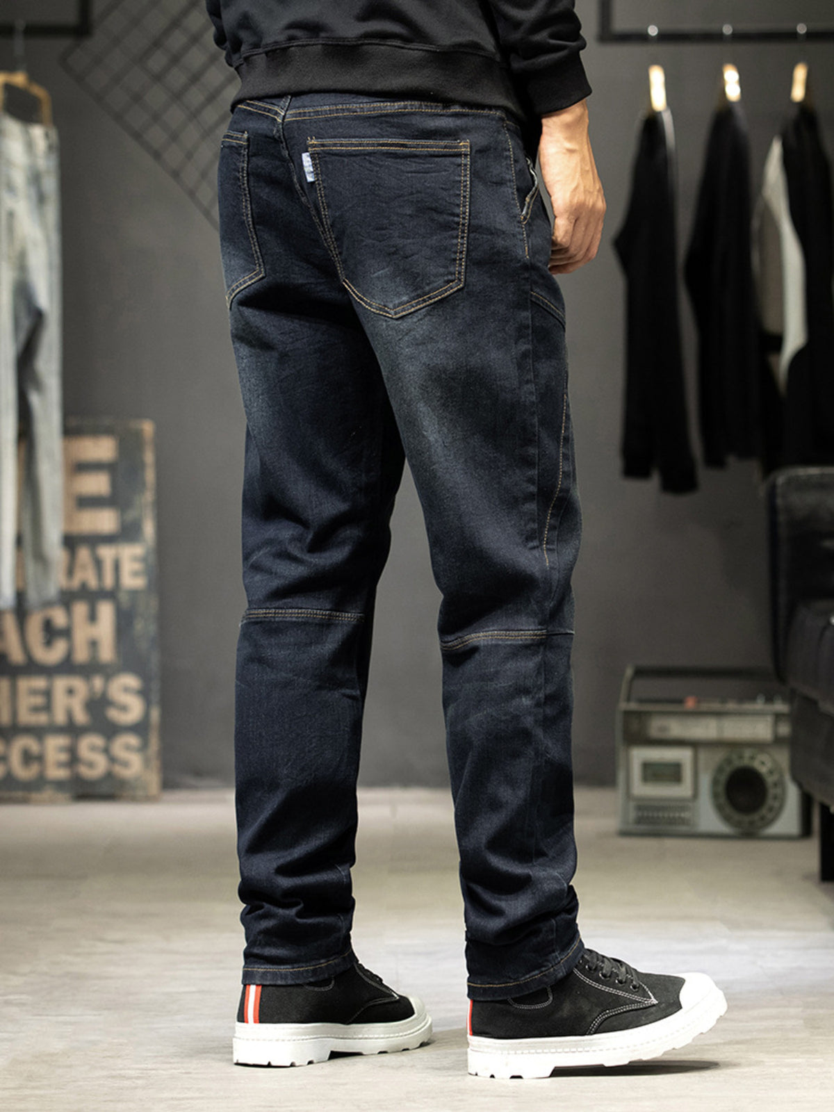 Men's slim-fit washed jeans with back pocket detail and panel seams, dark wash