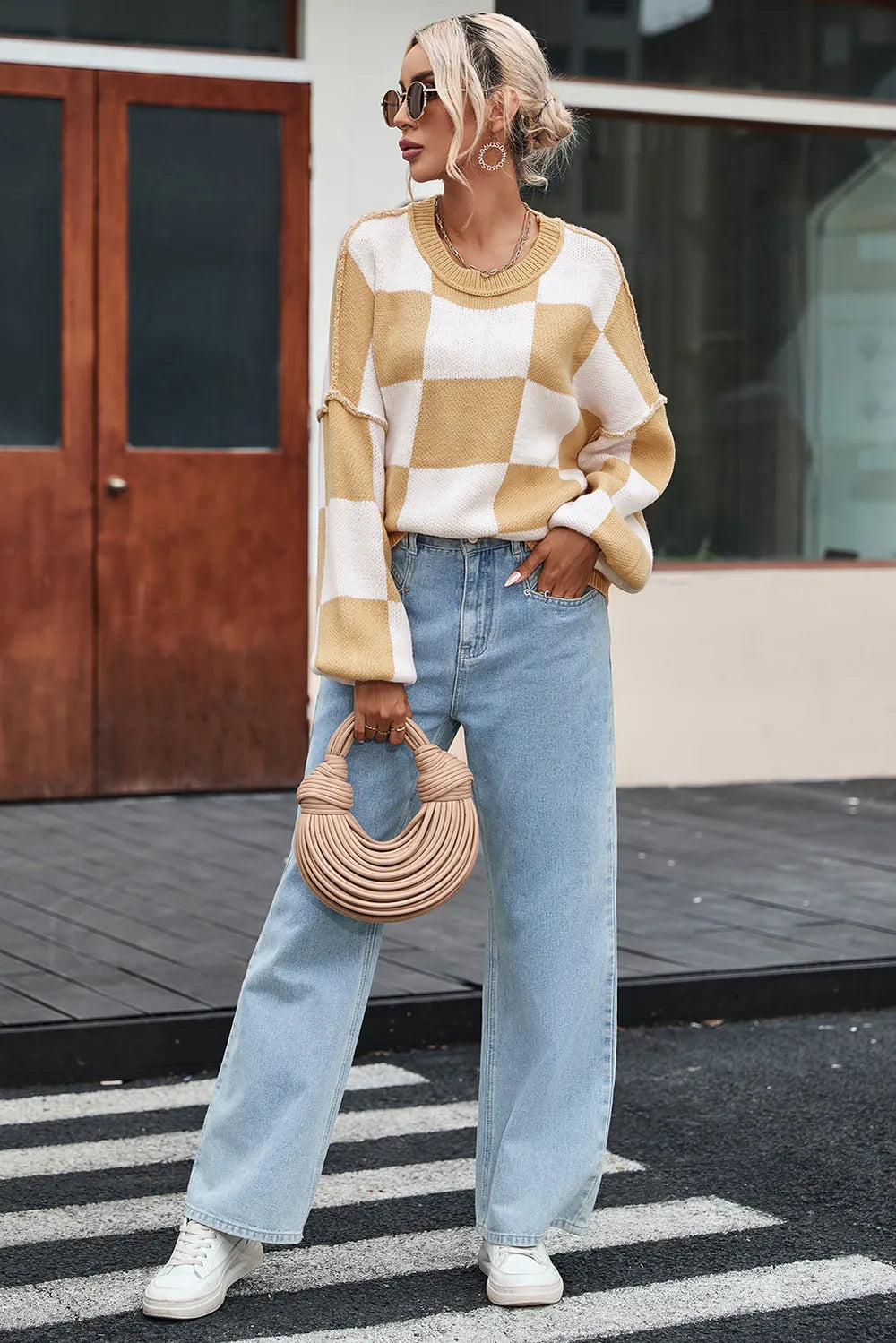 Tan and white checkered sweater with ribbed neckline, drop shoulders, and wide cuffs