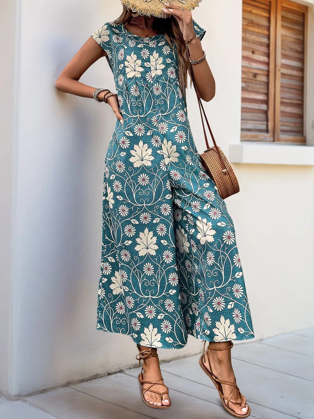 Turquoise floral printed wide-leg jumpsuit with round neck and cap sleeves, front view