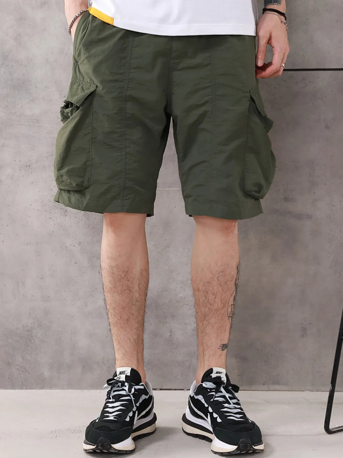 Men's light green drawstring nylon cargo shorts with flap pockets