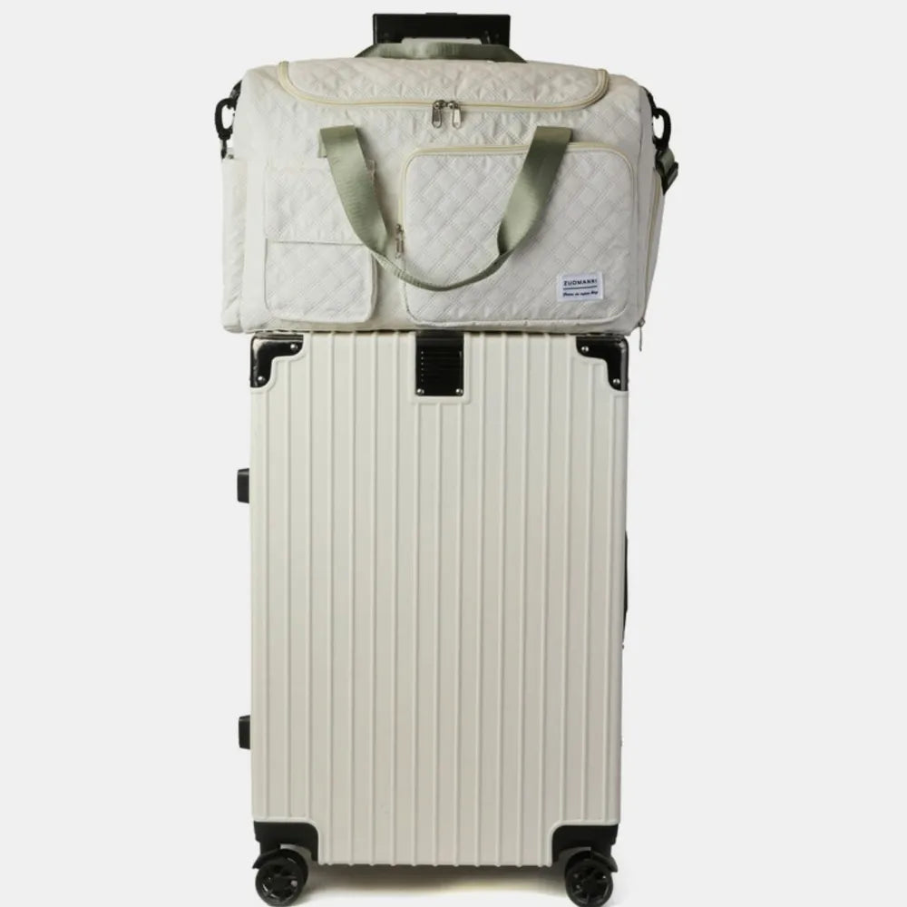White travel bag with front pockets, top handle, and four rolling wheels