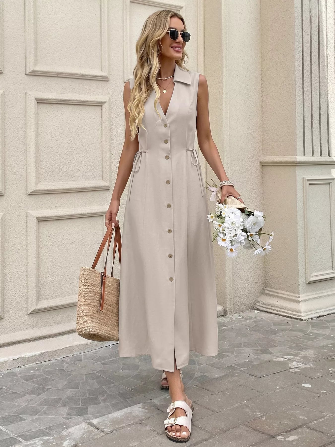 Cedar & Moore Sleeveless Button-Down Midi Dress in beige with front buttons, waist ties, and a slit