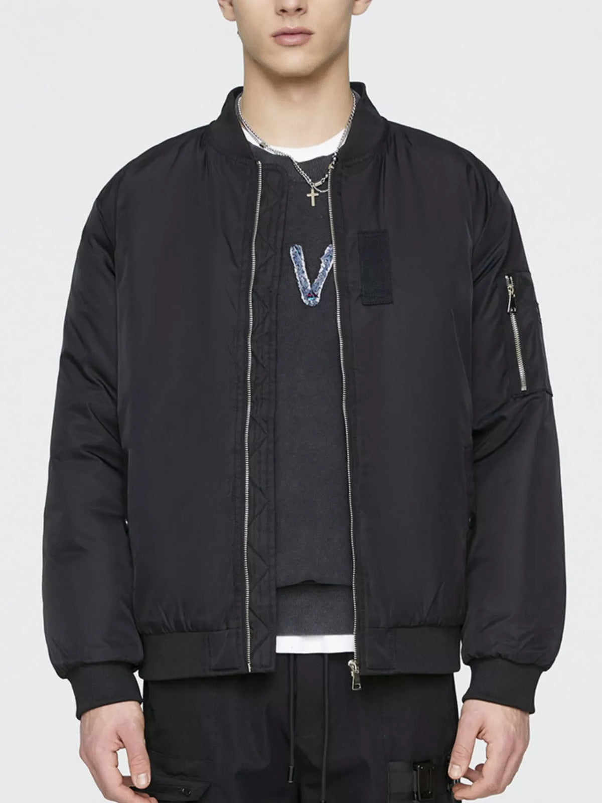Lightweight black bomber jacket with front zipper and chest patch pocket, ribbed cuffs