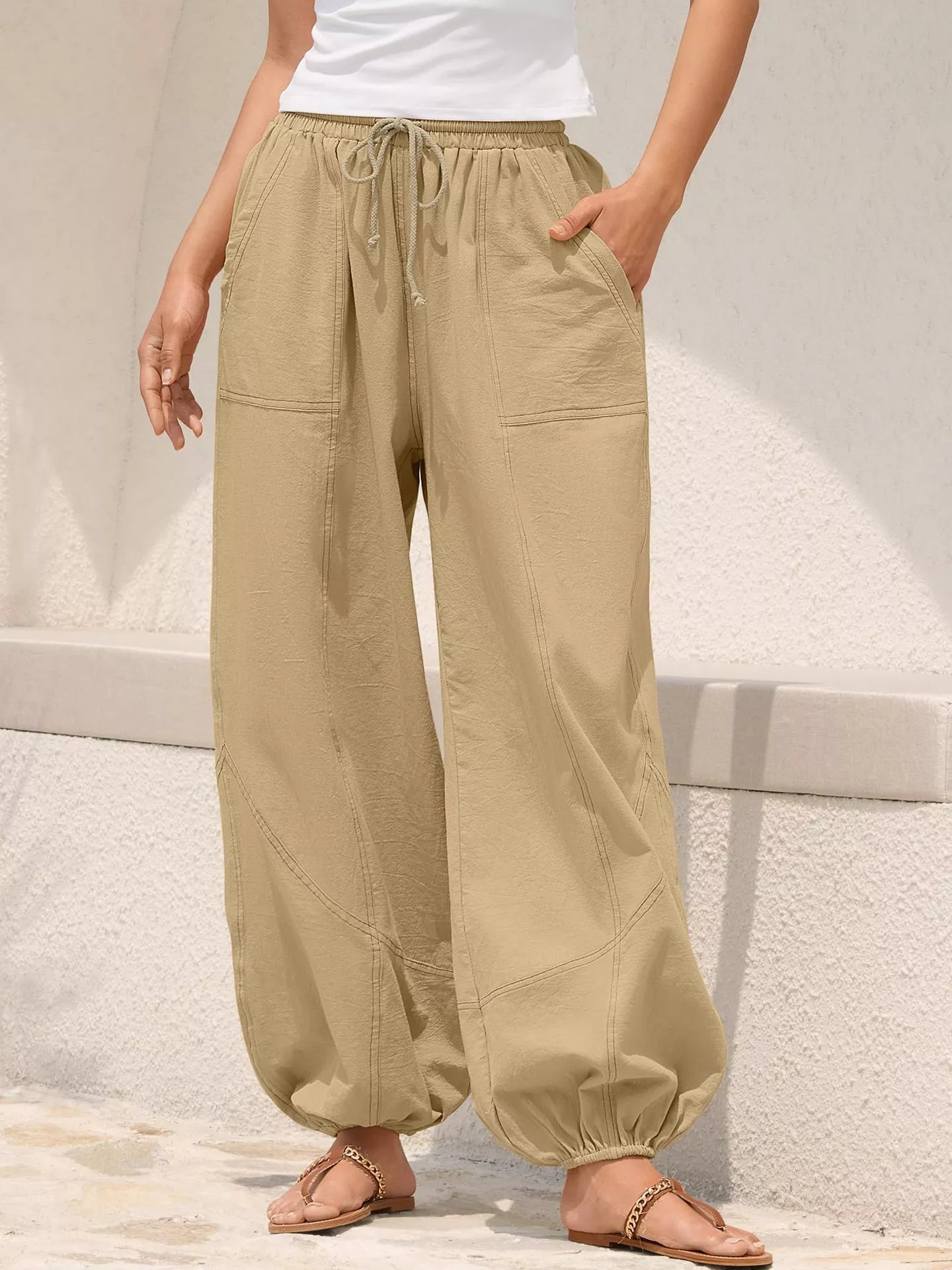 Tan loose-fit harem joggers with drawstring waist and side pockets