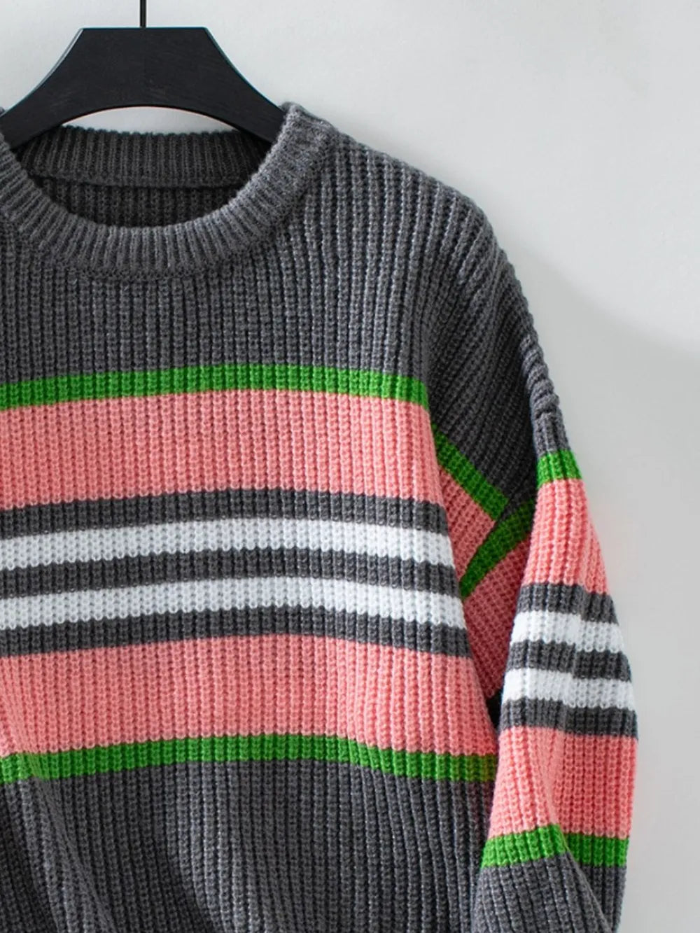 Dark gray round-neck long-sleeve sweater with green, white, pink contrast stripes