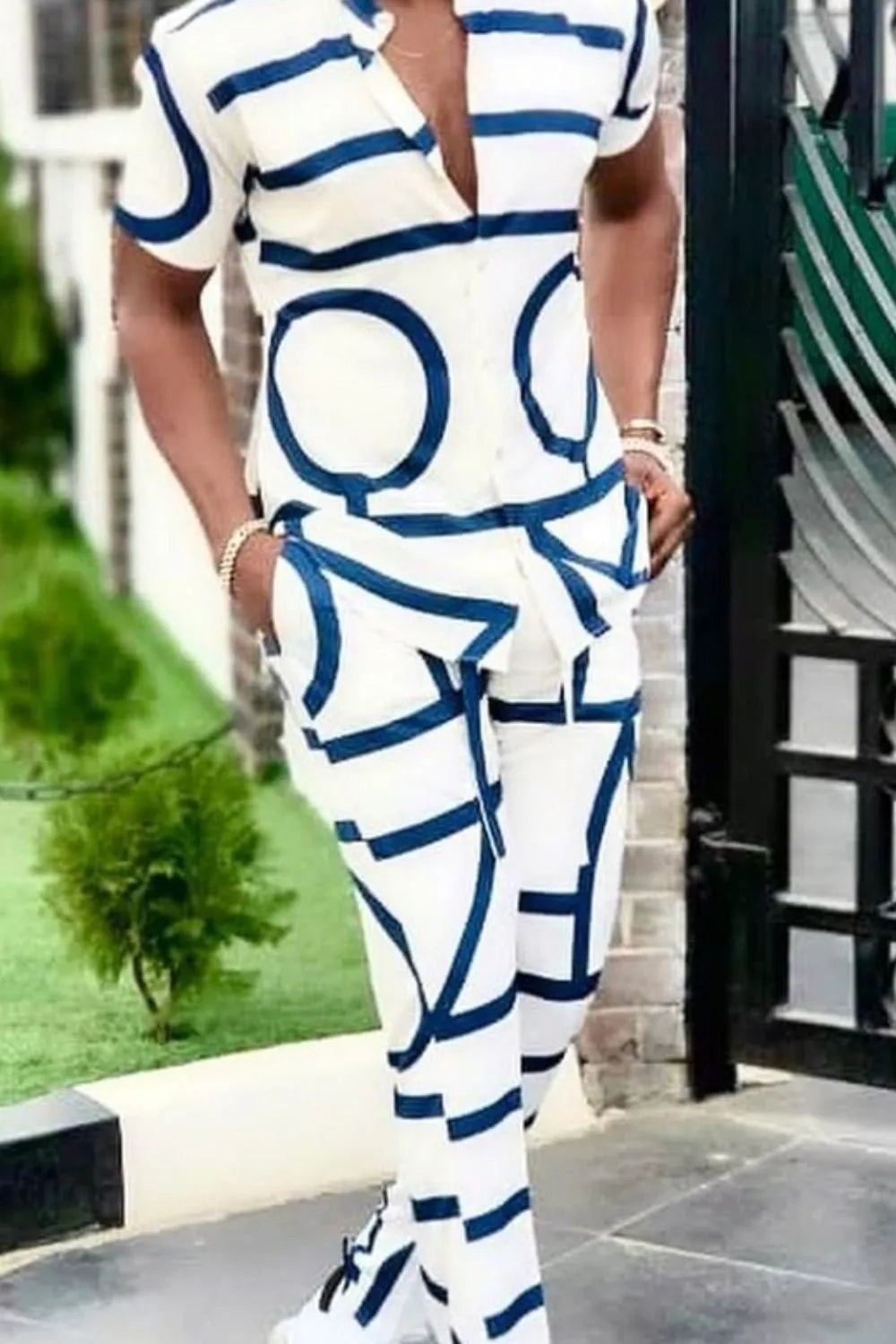 Men's short-sleeve two-piece outfit in white with blue abstract print, close-up of top and pants