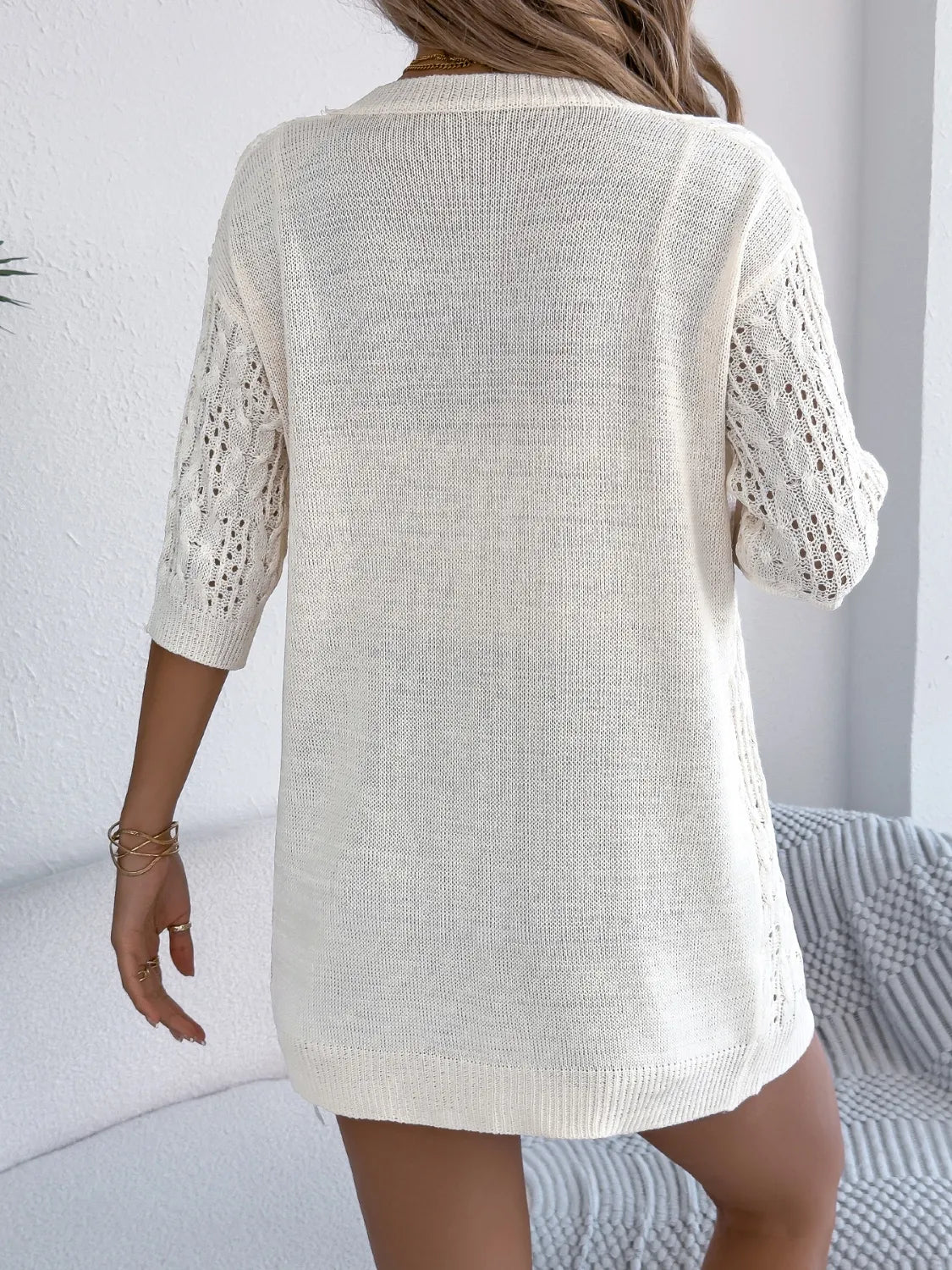 Off-white open-front half-sleeve openwork cardigan, back view with knit texture.