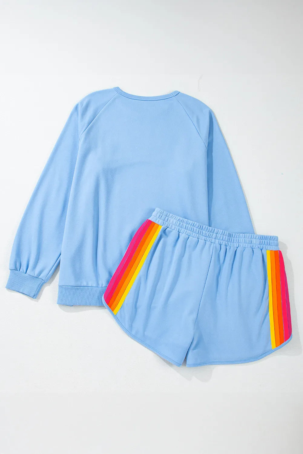 Round-neck top and shorts set in light blue with rainbow stripe accents on shorts