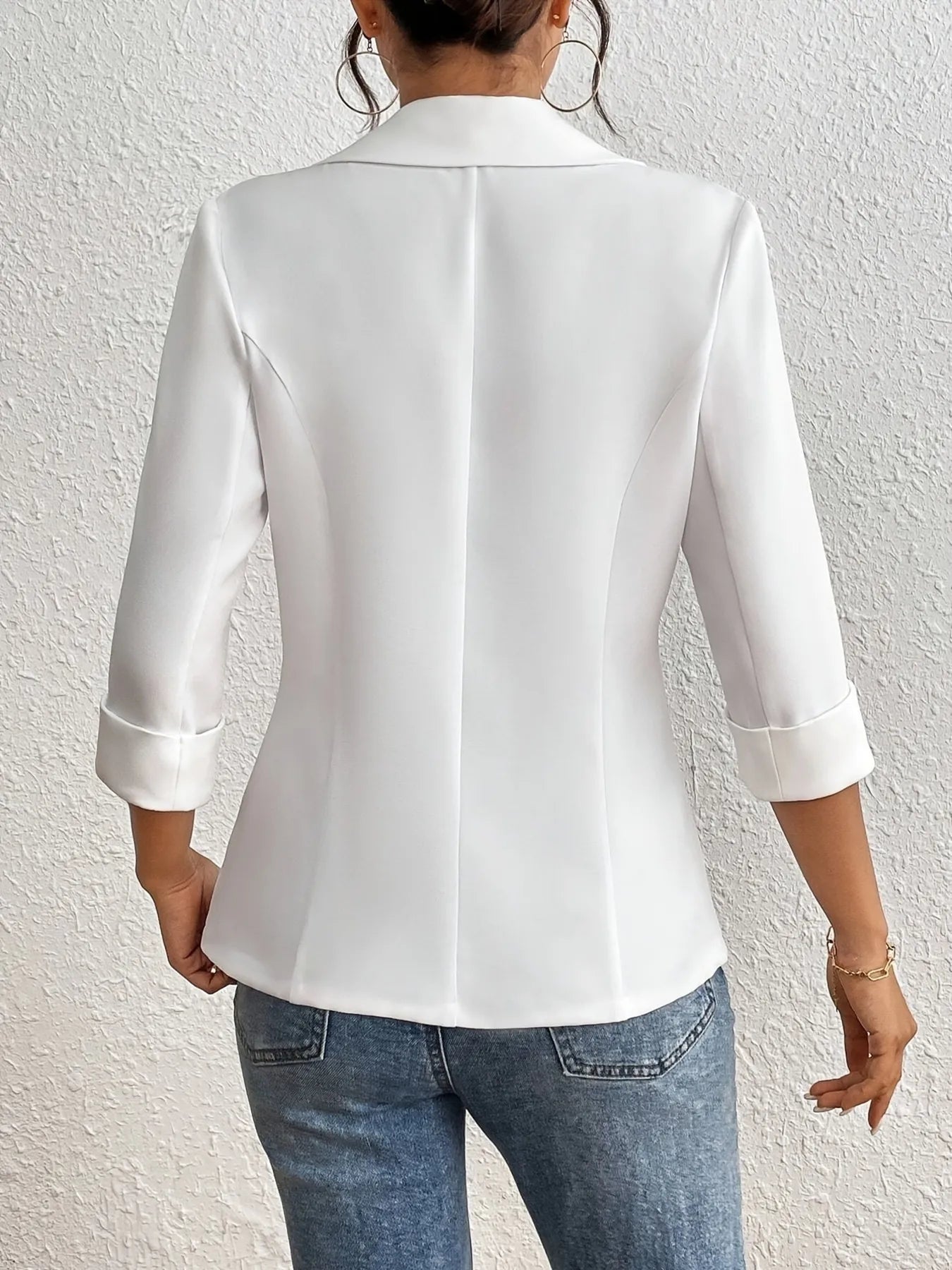 Back view of white blazer with 3/4 sleeves and smooth shoulder seams