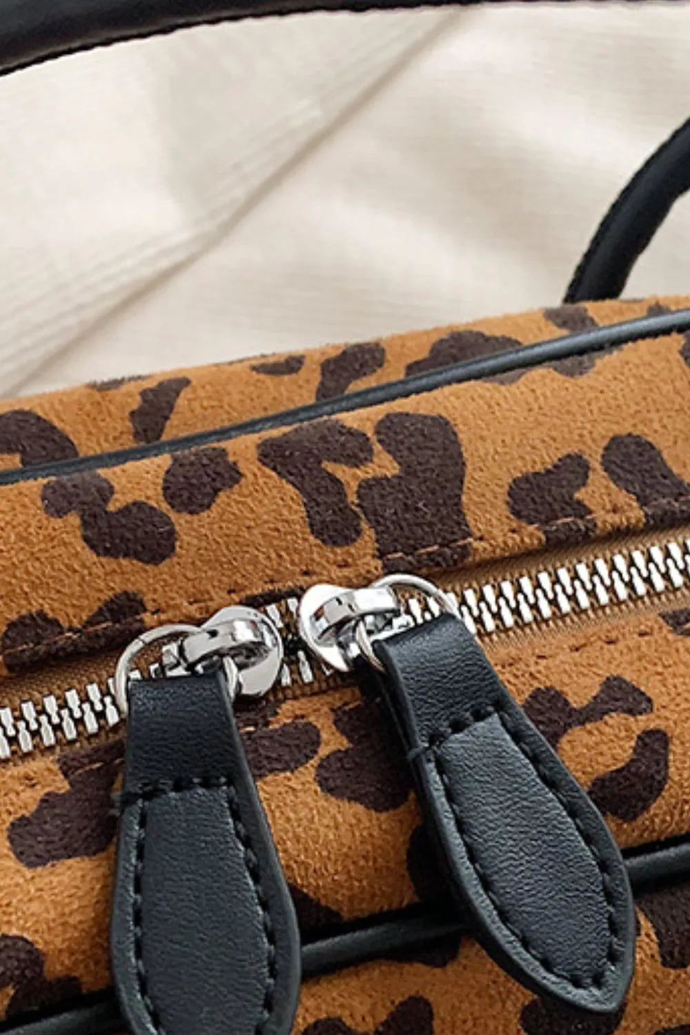 Caramel leopard suede bag with black leather zipper pulls and metal zipper track