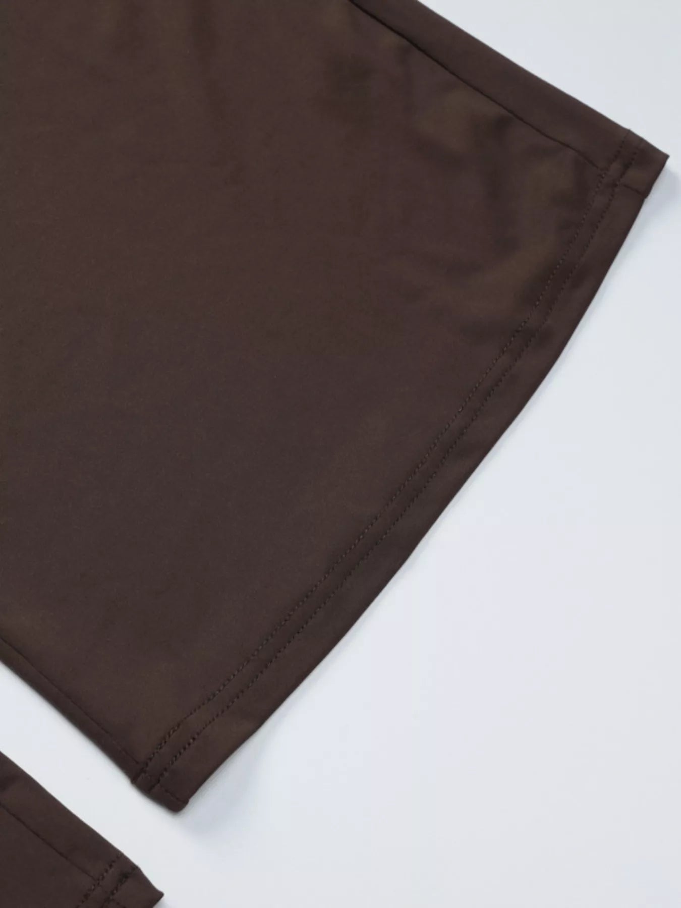 Dark brown crop top hem with stitched edge