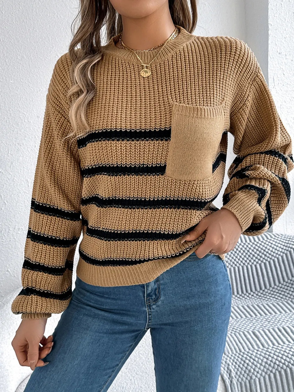 Caramel striped knit sweater with round neckline, long sleeves, and chest pocket