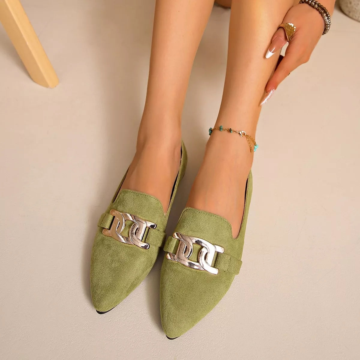 Matcha green suede pointed loafers with gold chain link buckle