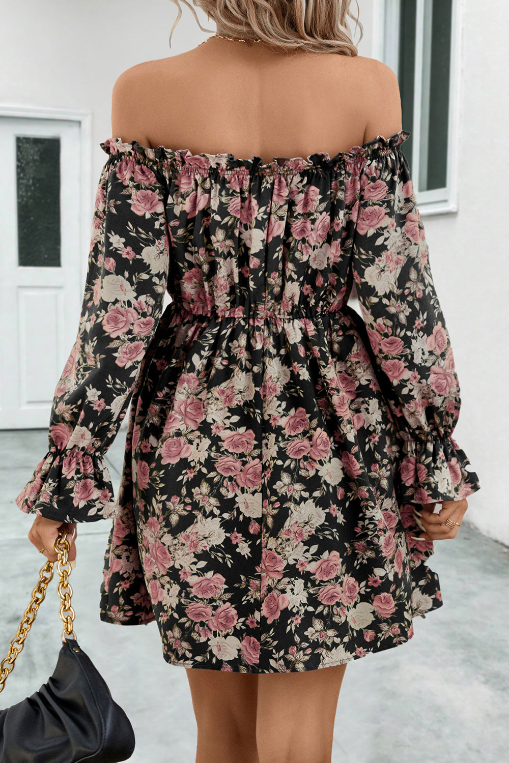Black floral off-shoulder dress, back view, gathered waist and long flounce sleeves