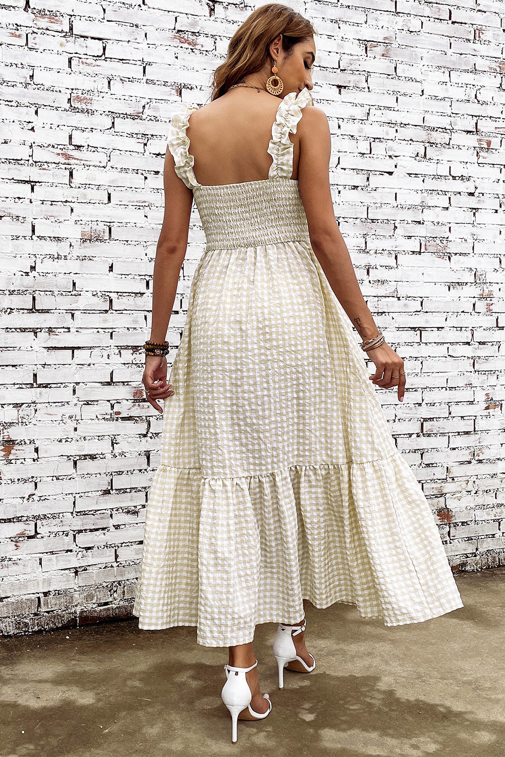 Back view square-neck plaid dress in cream with ruffle straps and tiered skirt
