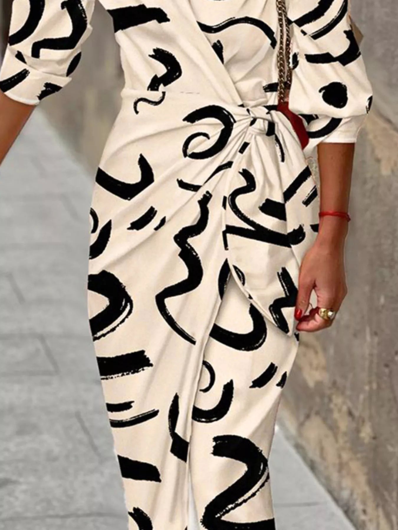 Cream wrap midi dress with black abstract print and tied waist belt, V-neck