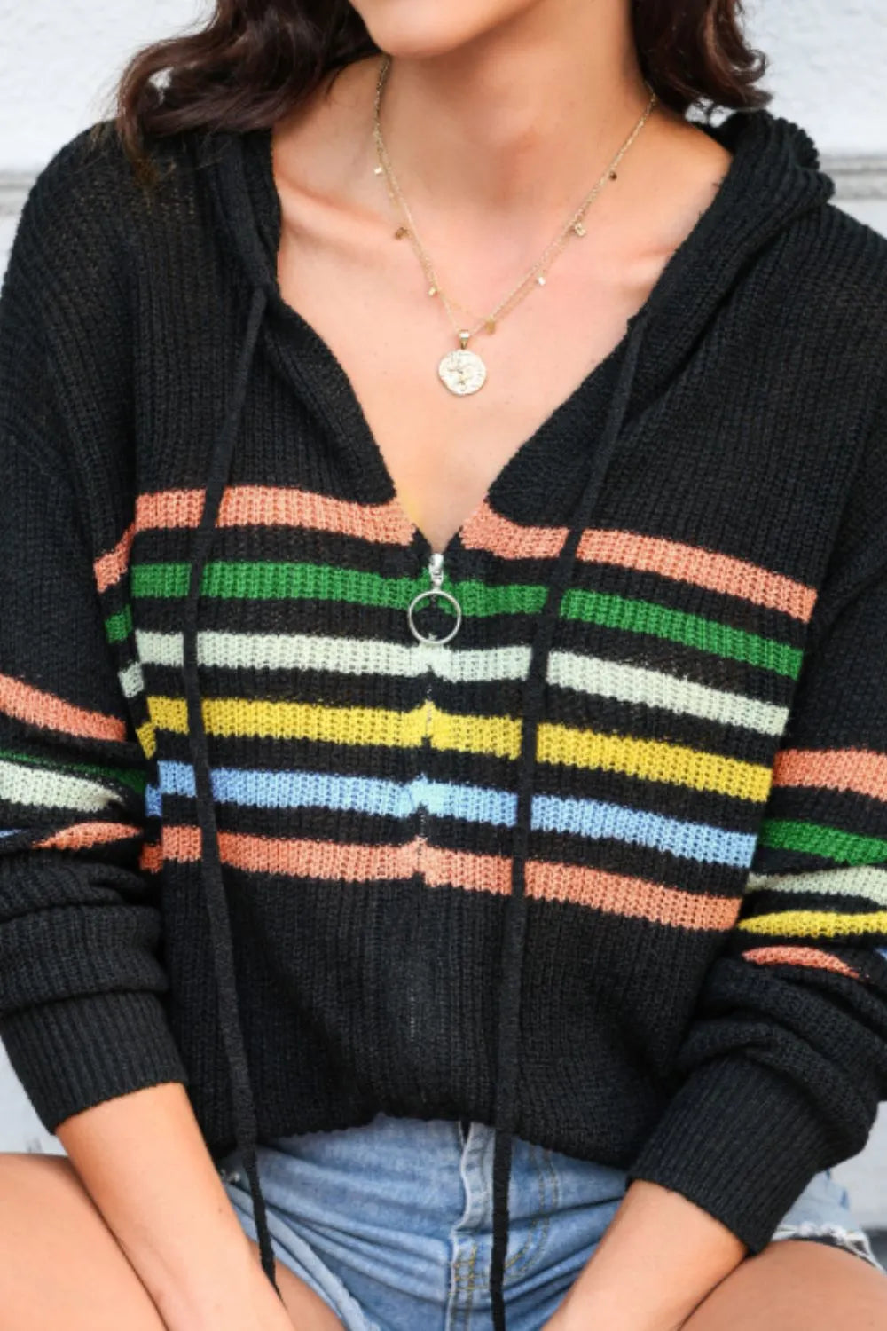 Black hooded zip-up sweater cardigan close-up with multicolor striped front placket