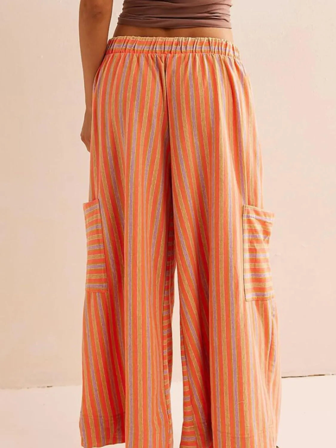 Orange vertical striped wide-leg pants with elastic waist and contrast patch pocket