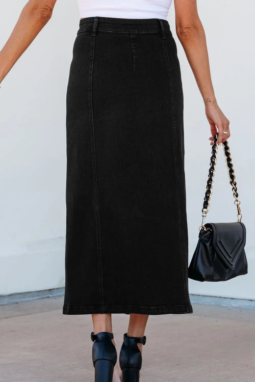 Black denim midi skirt with straight waistband and button-front detail; side slit at hem