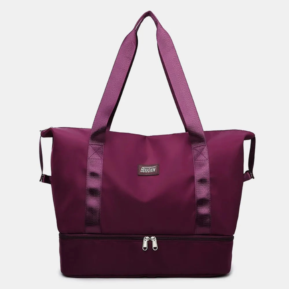 Plum purple nylon travel duffel bag with wide straps and front zip pocket.