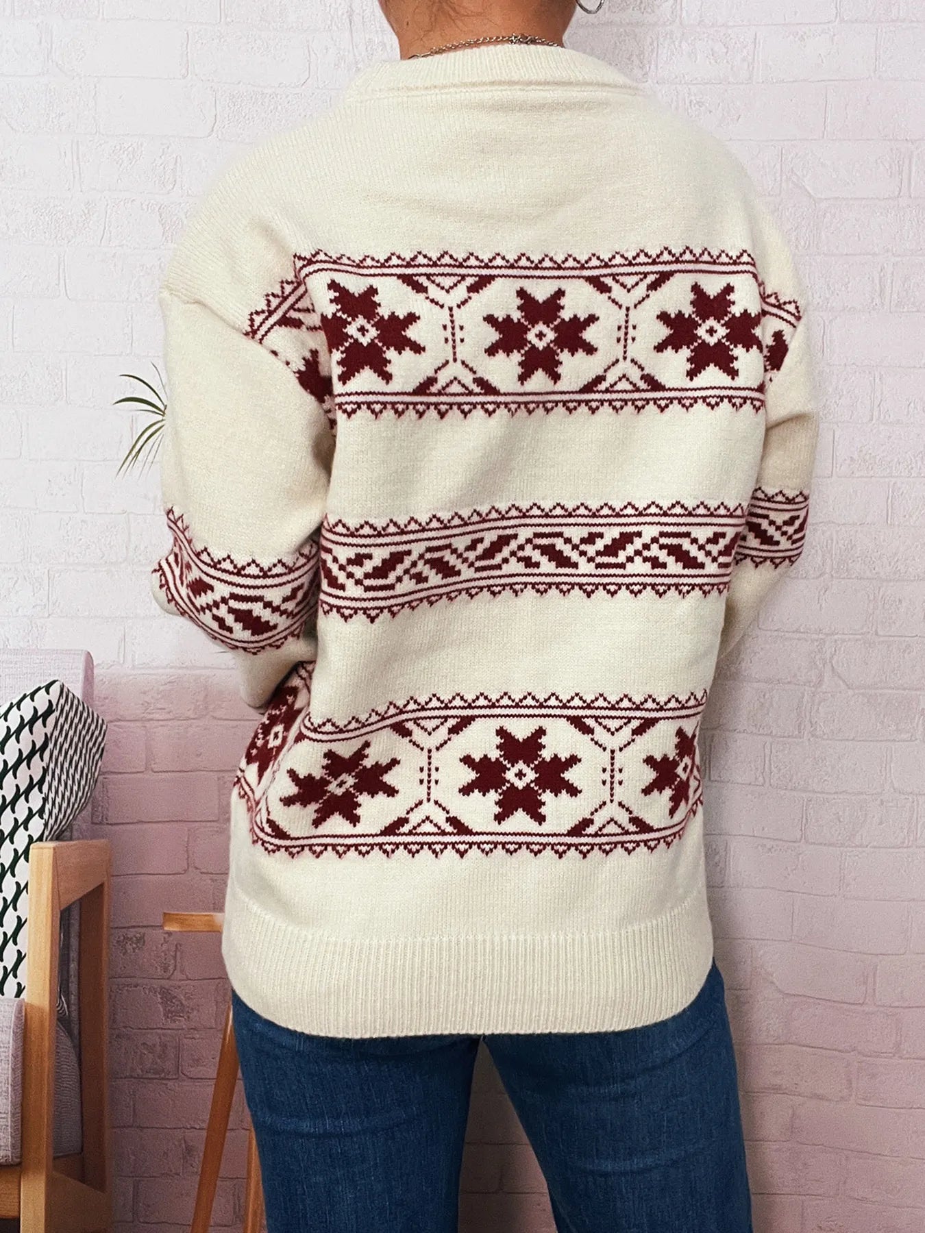White sweater back view with red snowflake Fair Isle pattern and stripe bands