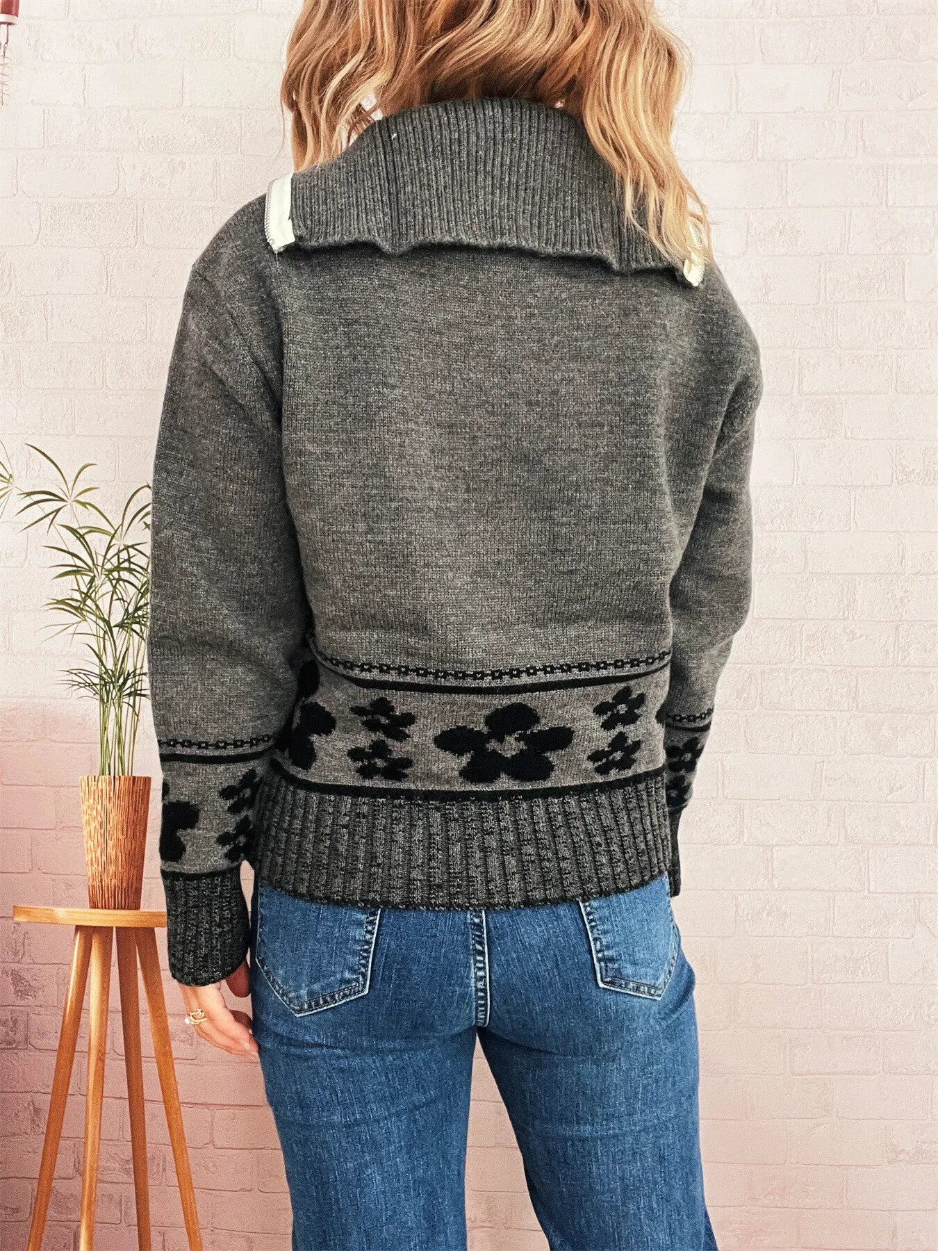 Gray long-sleeve sweater with half-zip collar and black floral band detail