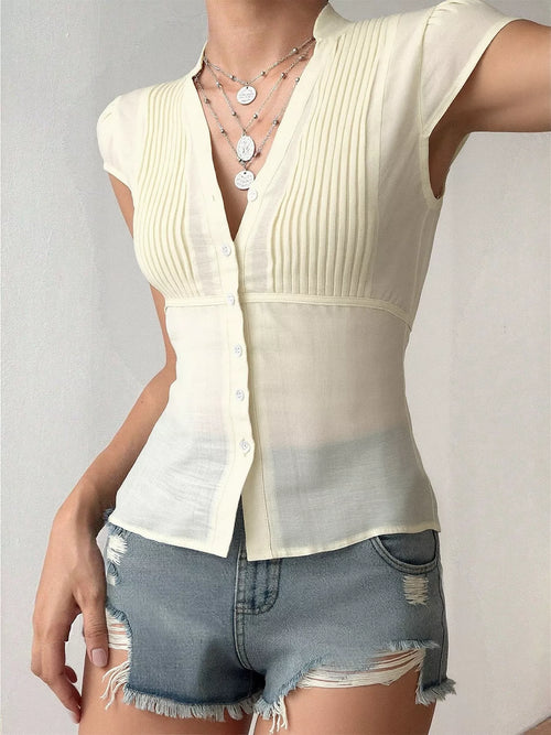 Cap-sleeve button-up shirt in light cream with vertical ribbed texture and front buttons