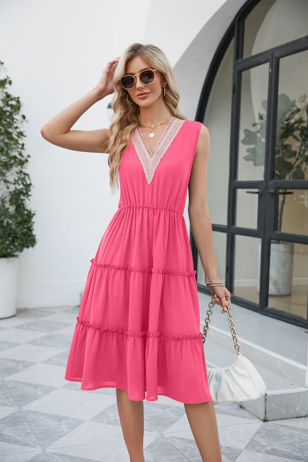 Hot pink sleeveless V-neck tiered dress with contrast trim, midi length