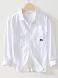 White button-up long sleeve shirt with chest pockets and button front
