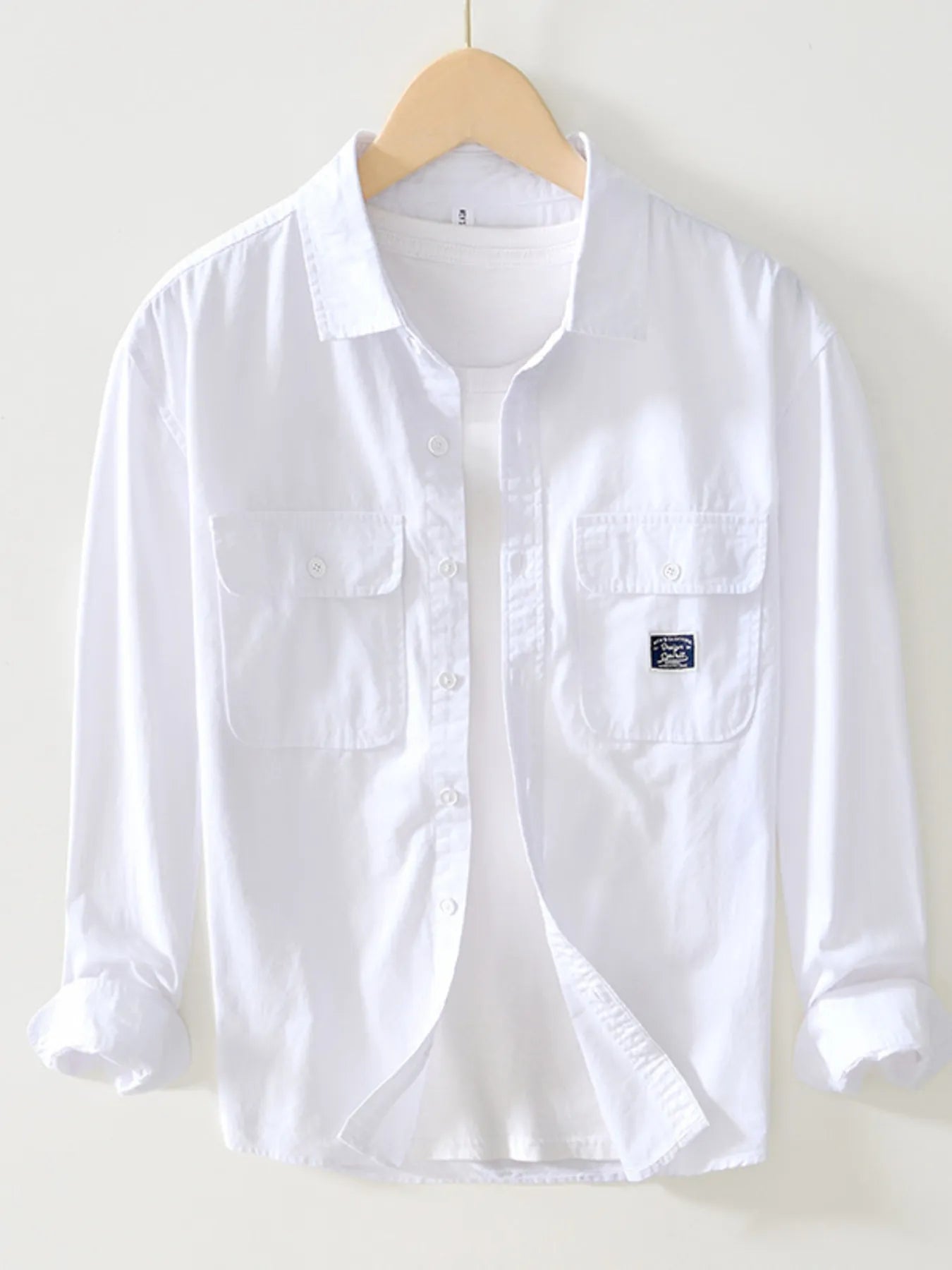 White button-up long sleeve shirt with chest pockets and button front