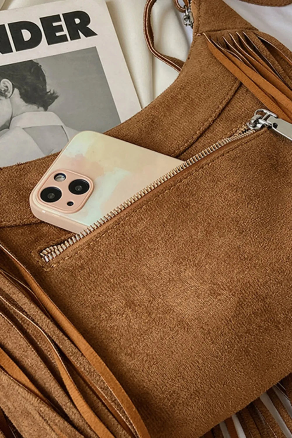 Tan suede zip pouch style shoulder bag with fringe and chain zipper pull