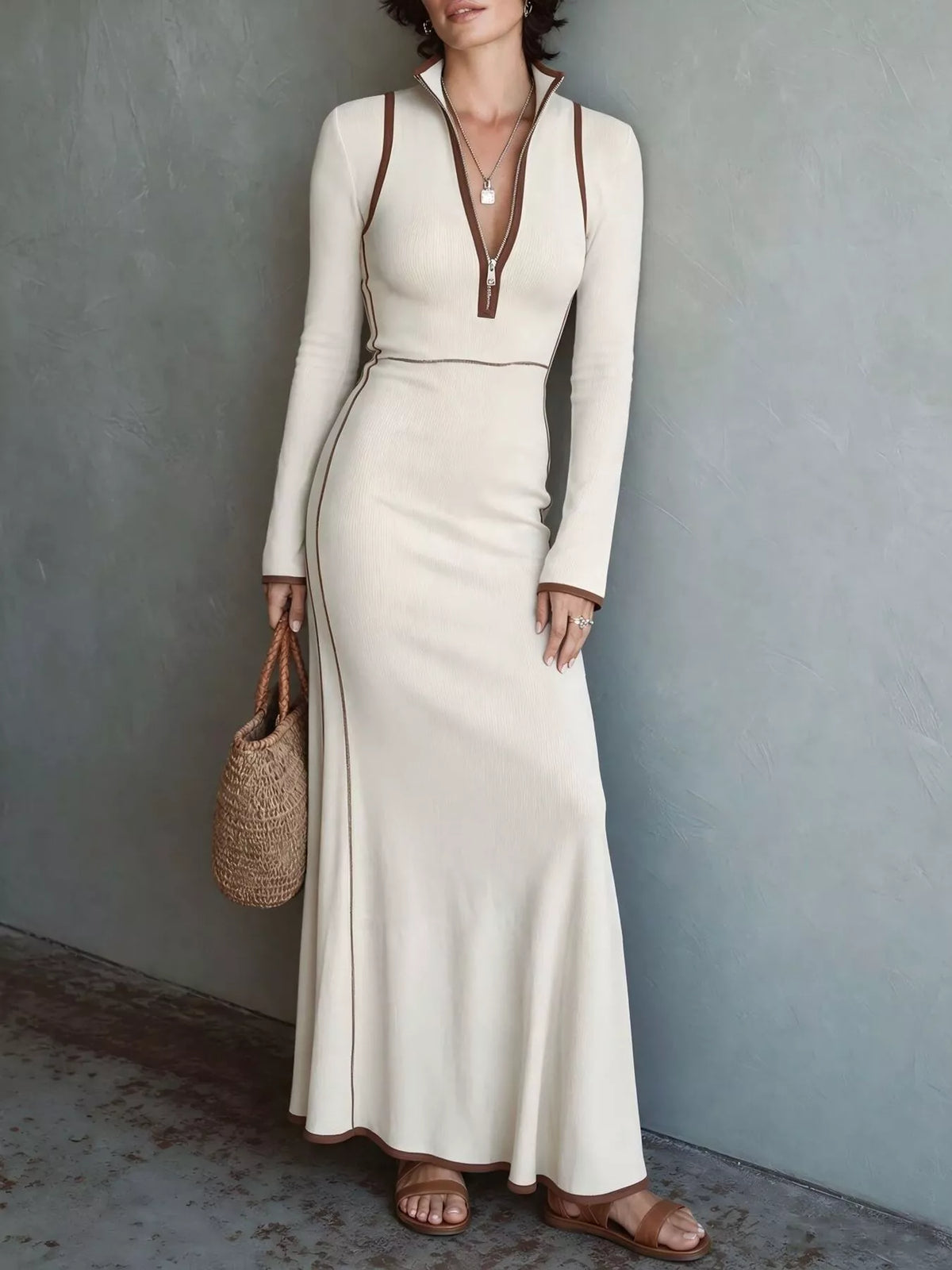 Cream knit maxi dress with long sleeves, front zip, and contrast trim