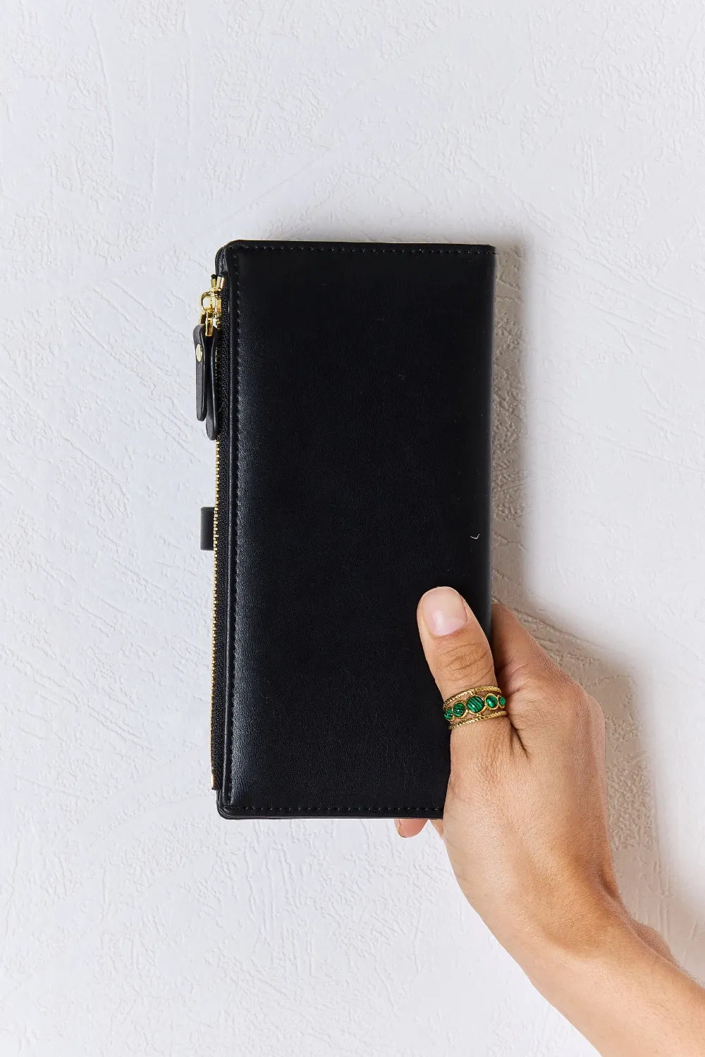 Black textured PU leather wallet with gold-tone zipper pull and slim flap front.