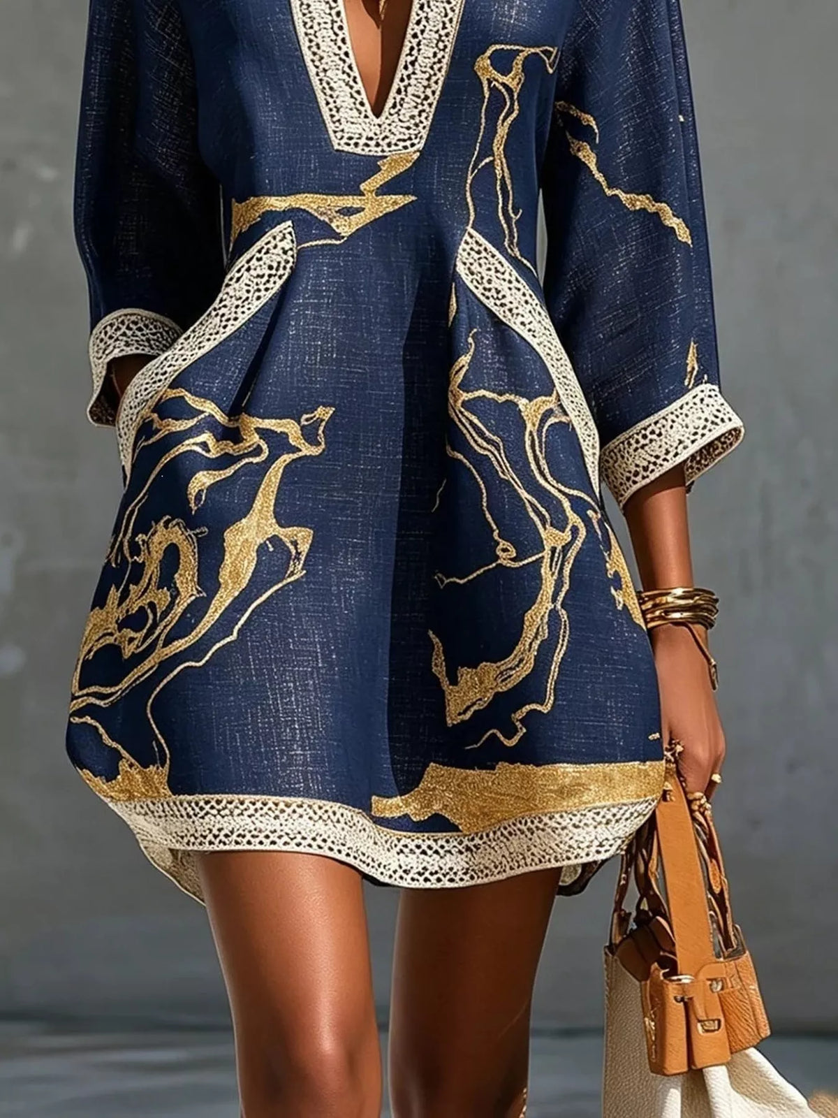 Navy relaxed mini dress with V-neck lace trim and gold abstract print