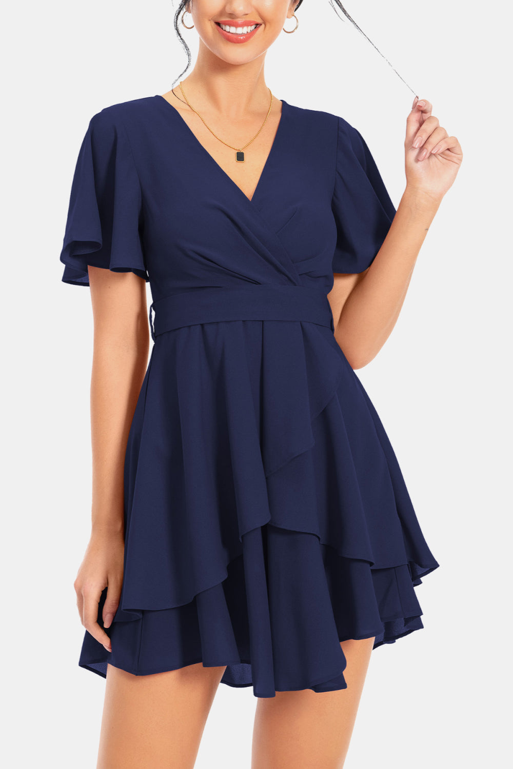 Dark navy surplice neck flutter sleeve dress with layered ruffle skirt and tied waist