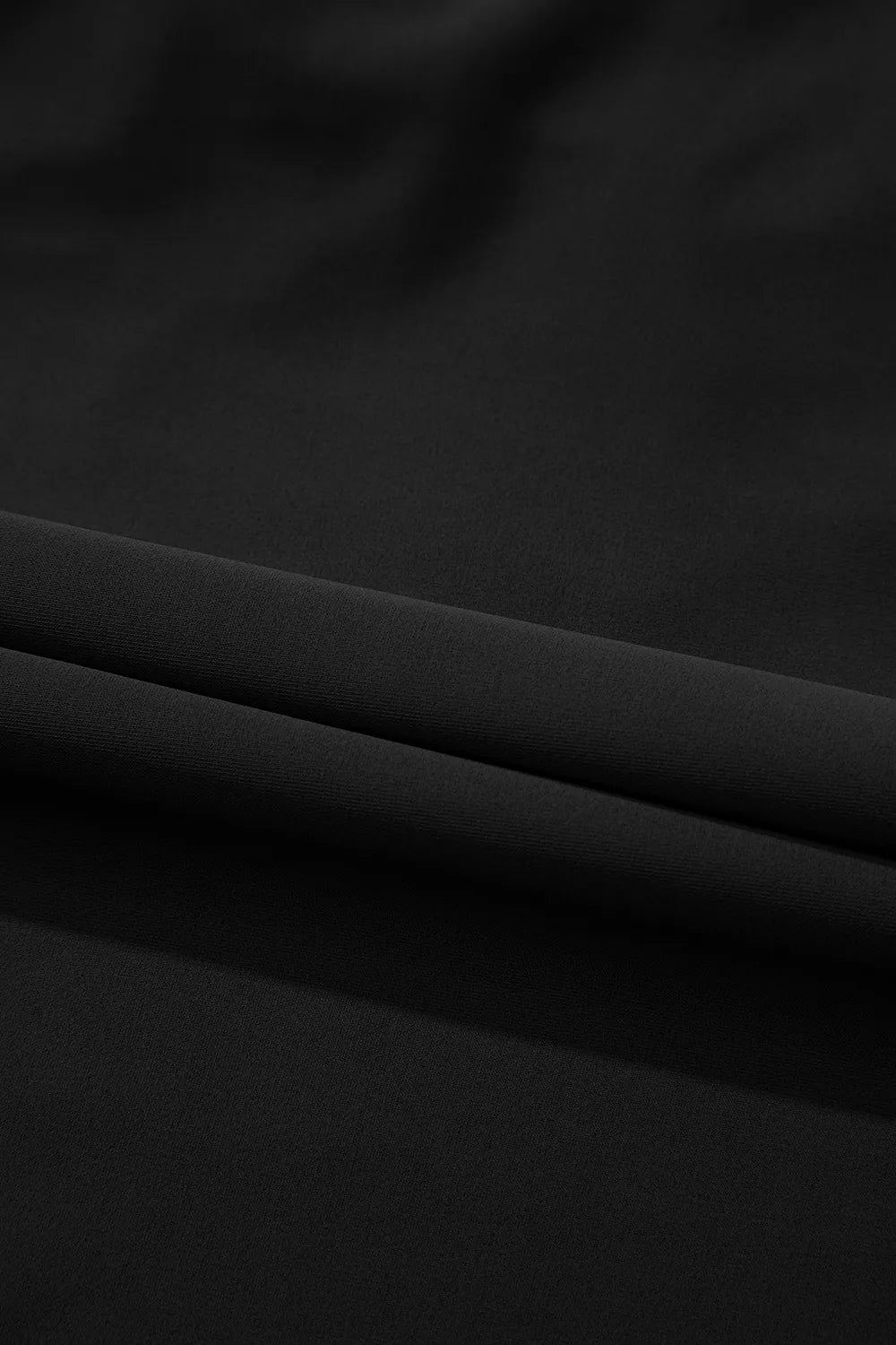 Black swimsuit fabric close-up with smooth, matte texture