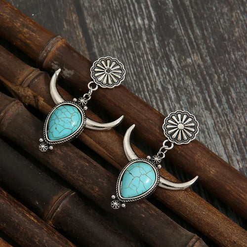 Turquoise teardrop dangle earrings with crescent horns and sunburst stud tops, silver-tone