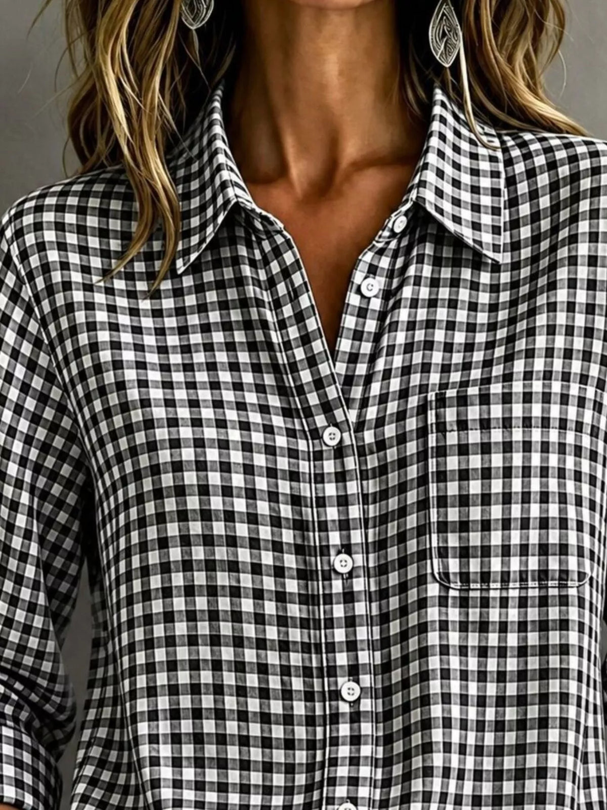 Black gingham button-down shirt close-up with button placket and chest pocket