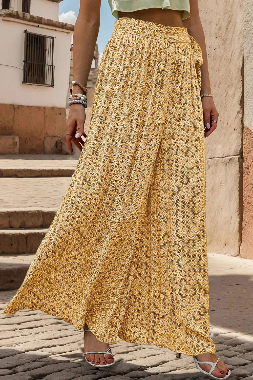 Yellow printed tied wide-leg pants with gathered elastic waistband and flowing wide legs