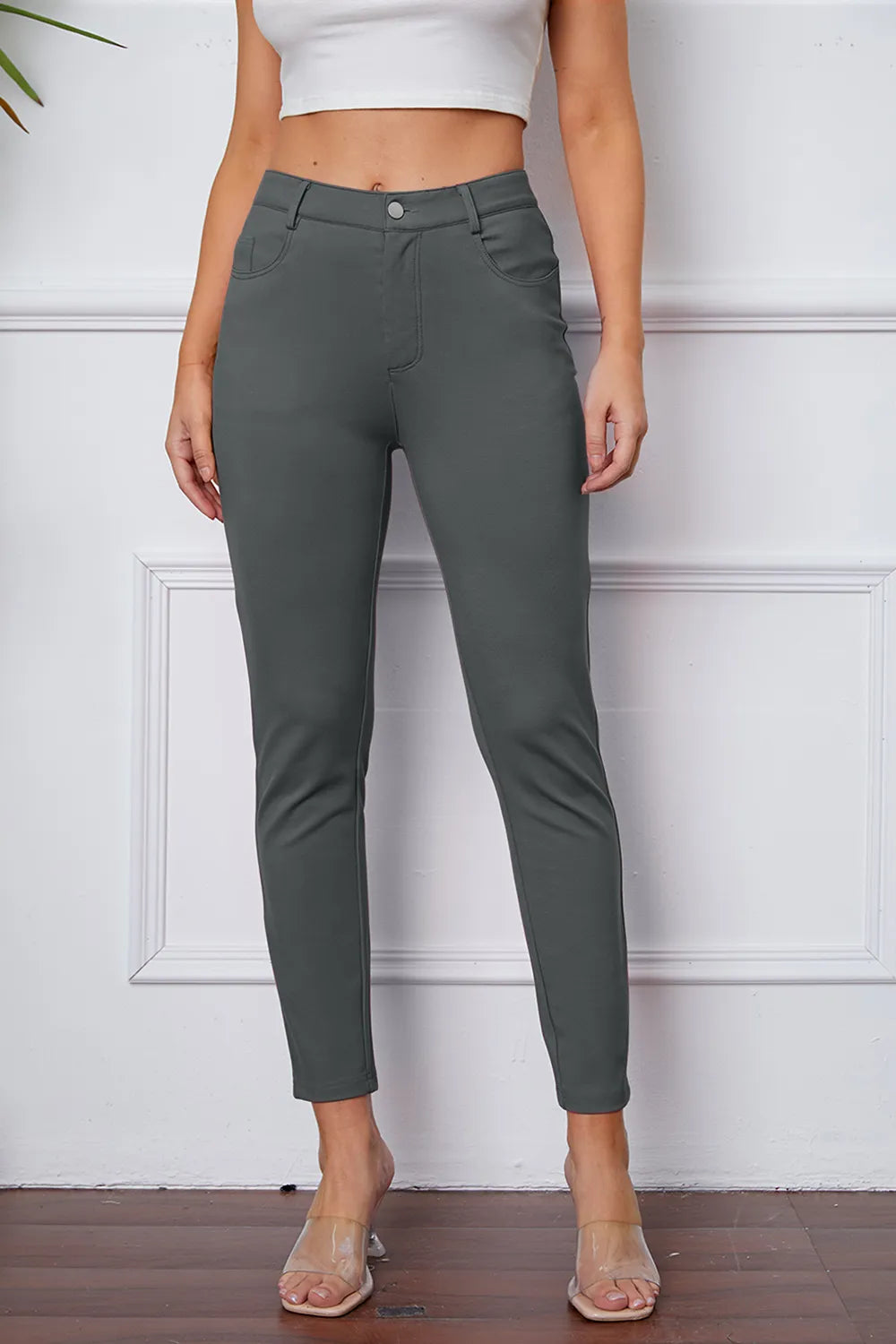Women's dark gray stretch pants with button, belt loops, and ankle-length slim fit