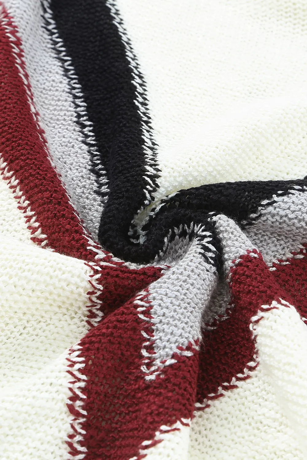 Chevron knit fabric close-up, cream base with burgundy and black zigzag stripes