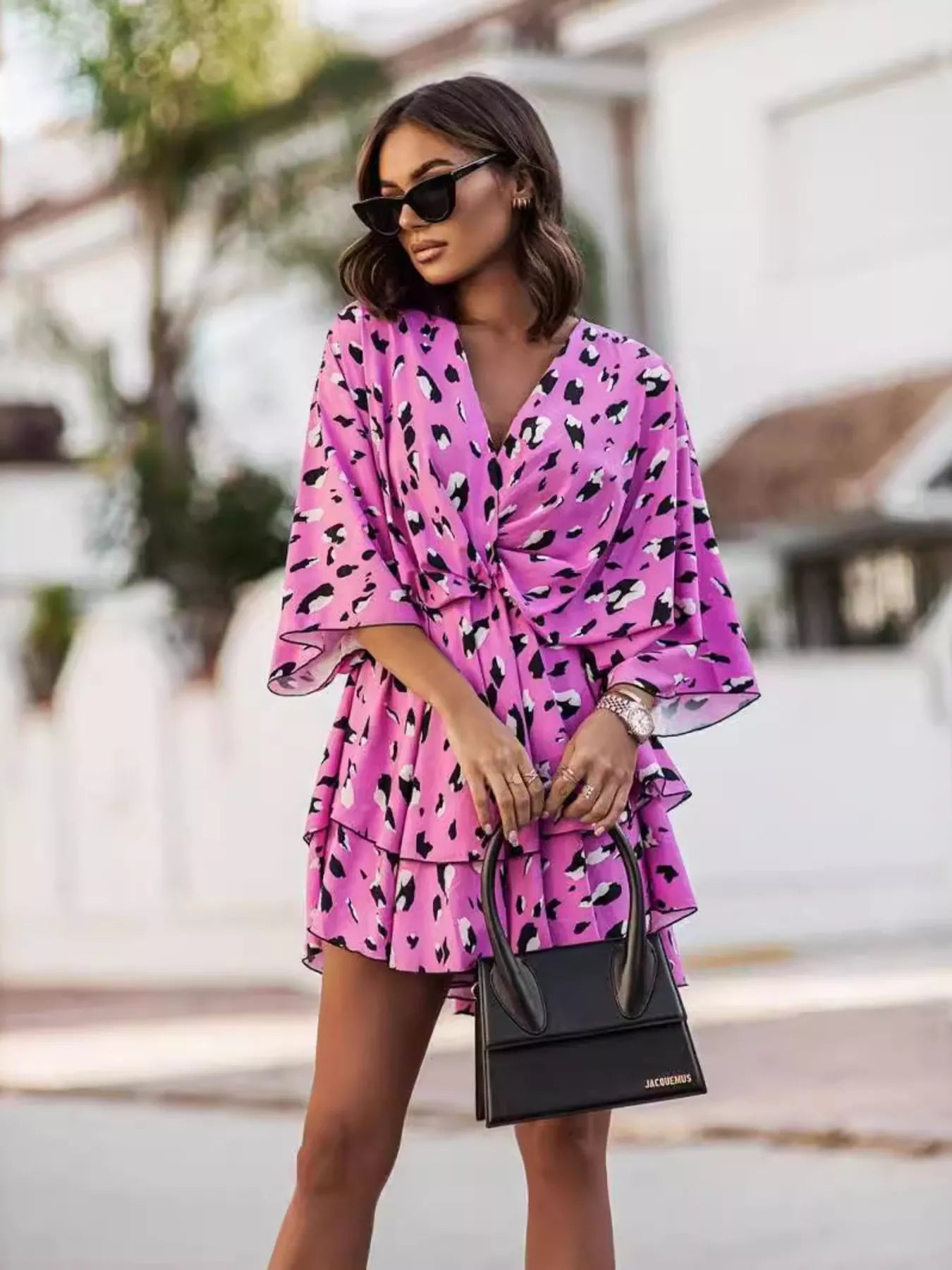 Printed surplice mini dress in hot pink with black abstract heart print, flutter sleeves