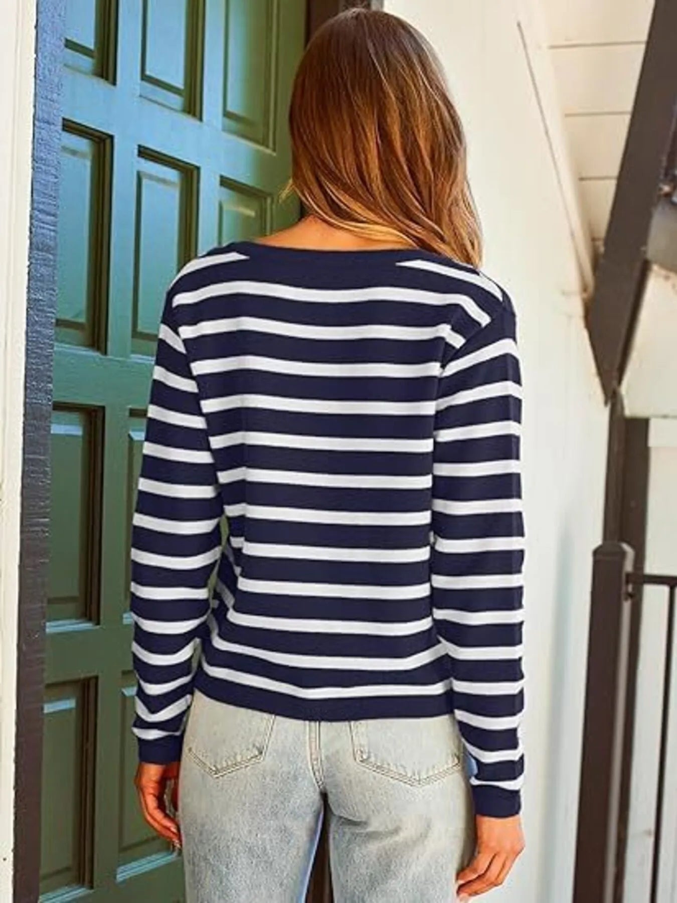 Navy-and-white striped button-up cardigan with long sleeves and gold button placket