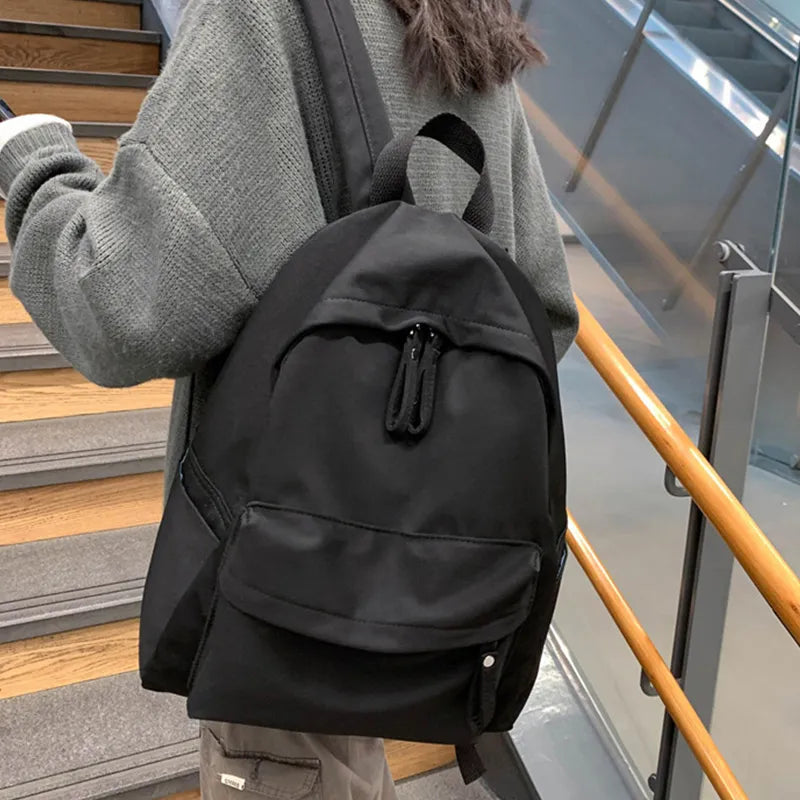 Zip cotton backpack with front zip pocket, black fabric and top handle
