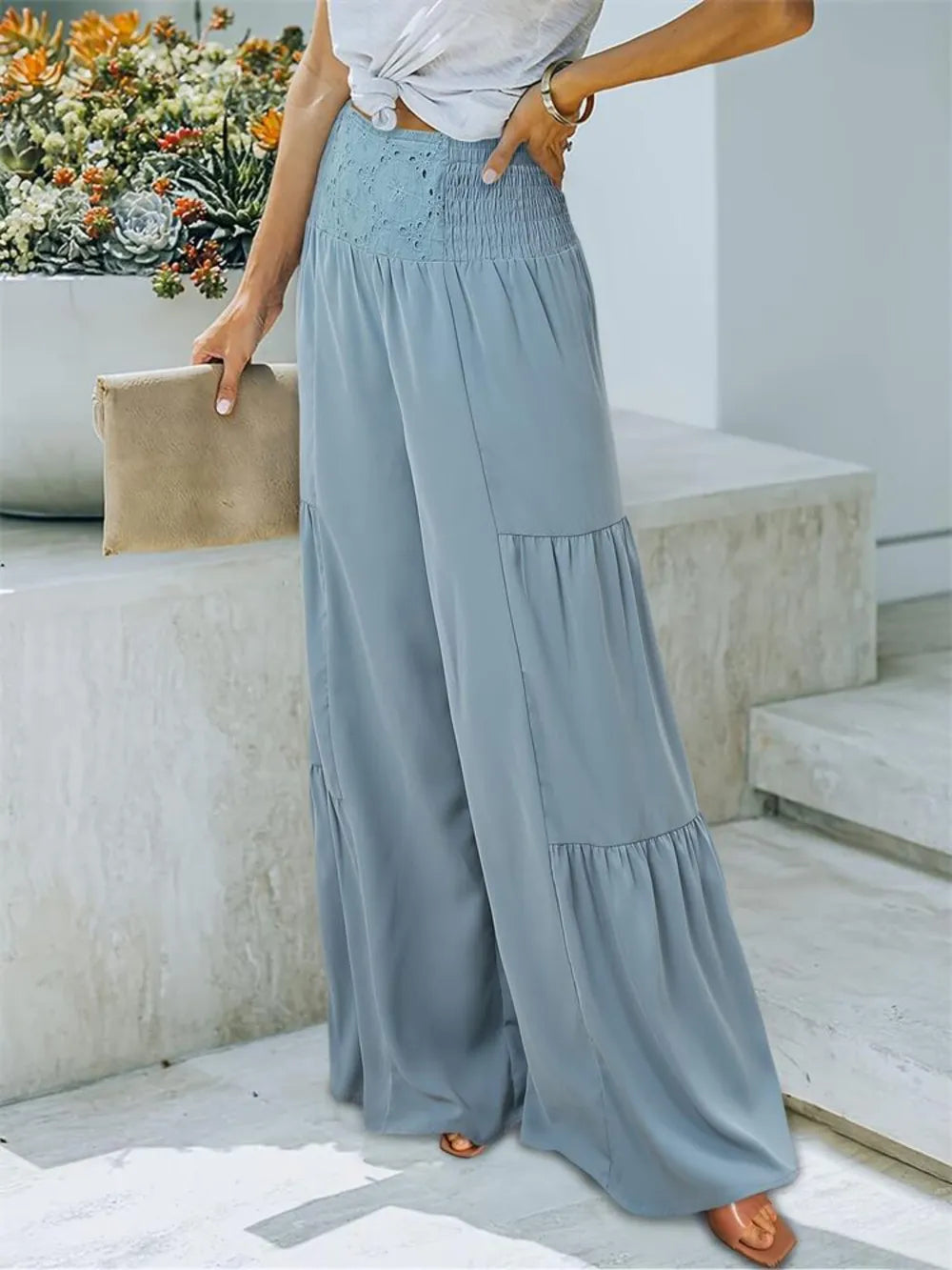 Light blue smocked high-waist wide-leg pants with layered ruffle tiers