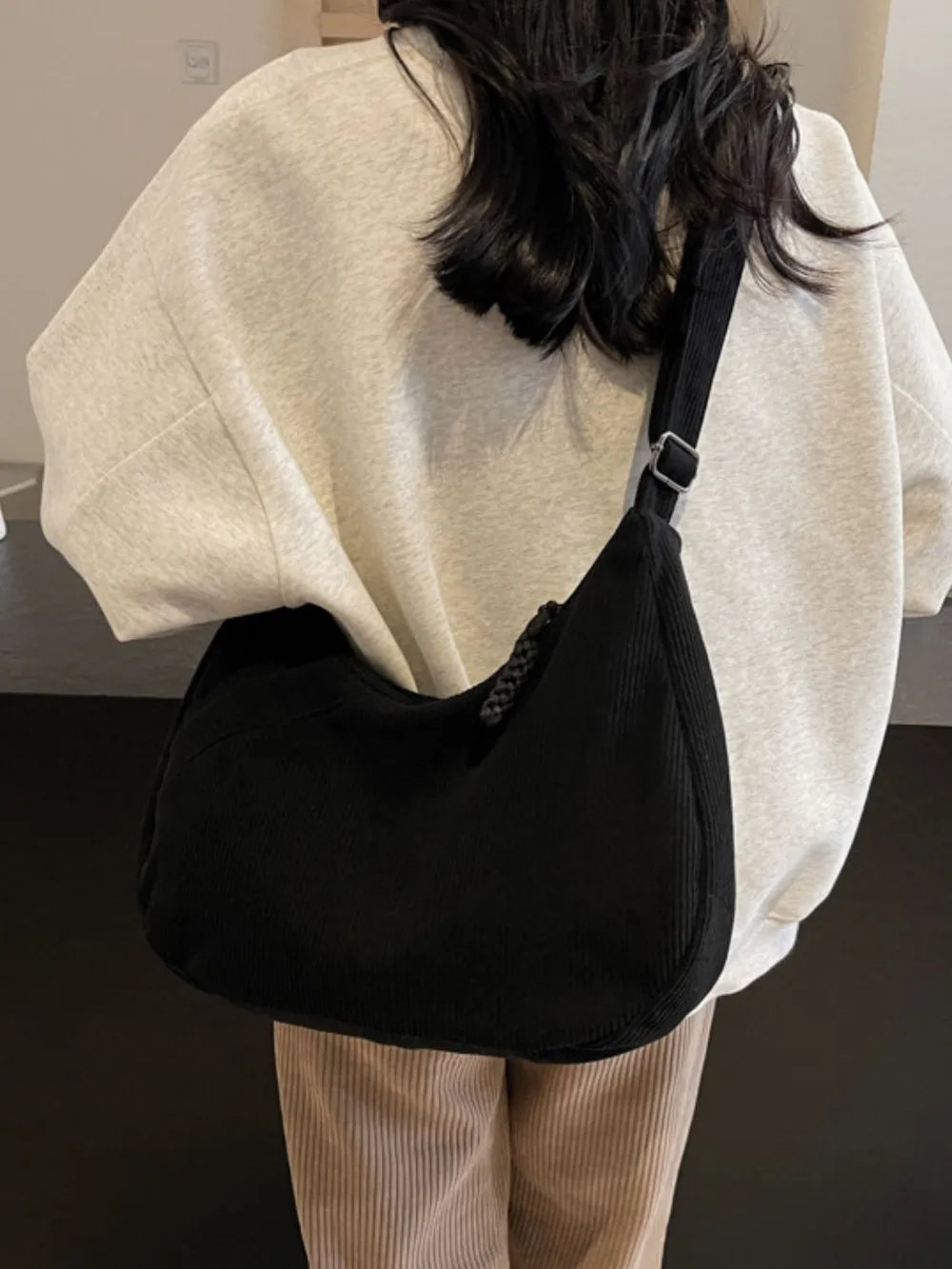 Cream ribbed shoulder bag with adjustable strap and drawstring top
