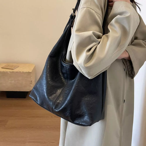 Black adjustable-strap shoulder bag, slouchy hobo shape with top zipper