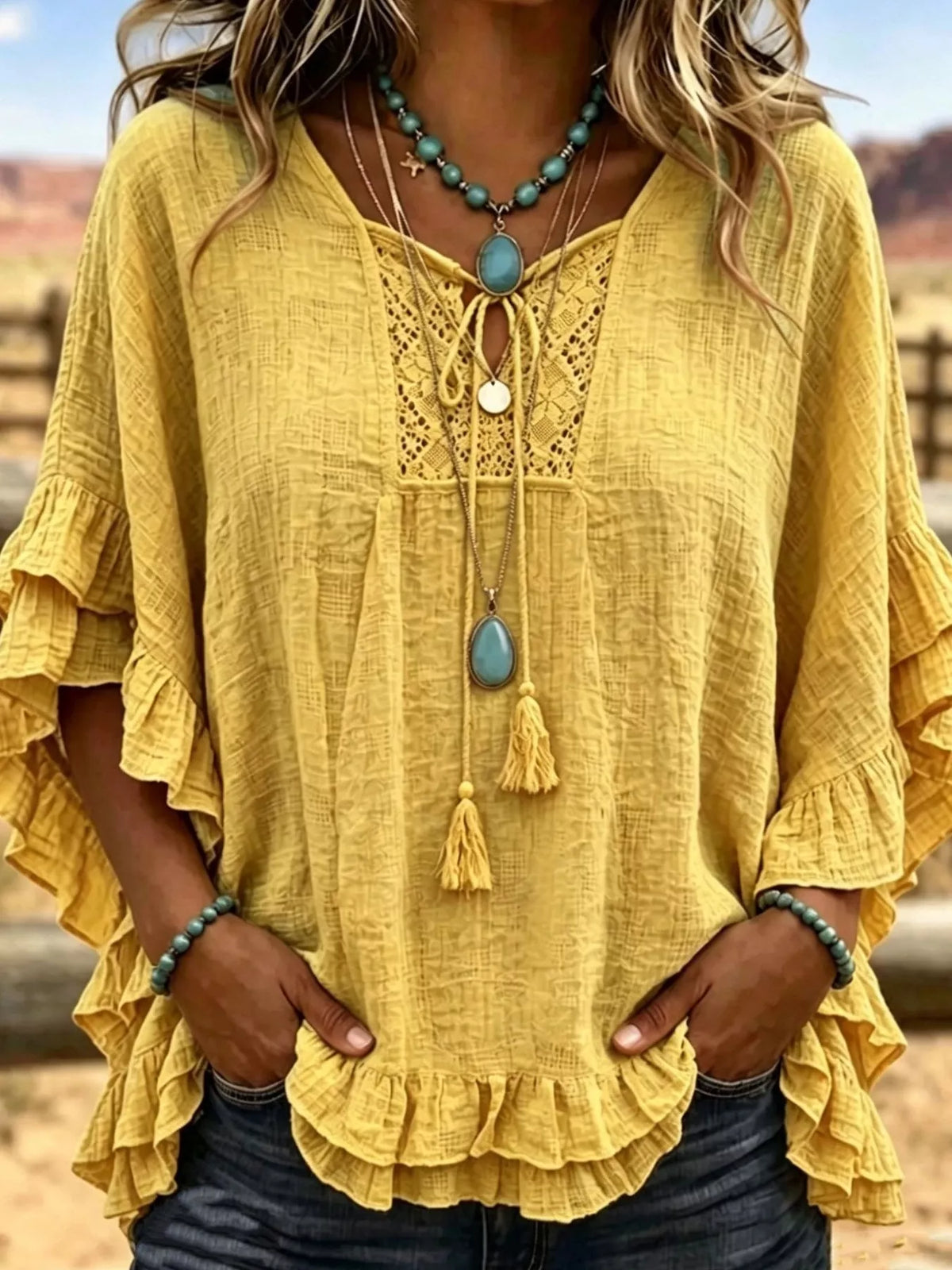 Yellow tie-neck polyester blouse with ruffled hem and lace yoke detail